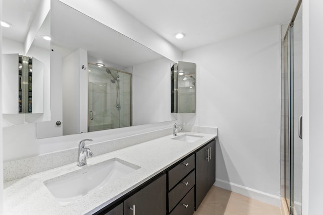 bathroom with vanity, tile patterned flooring, and an enclosed shower