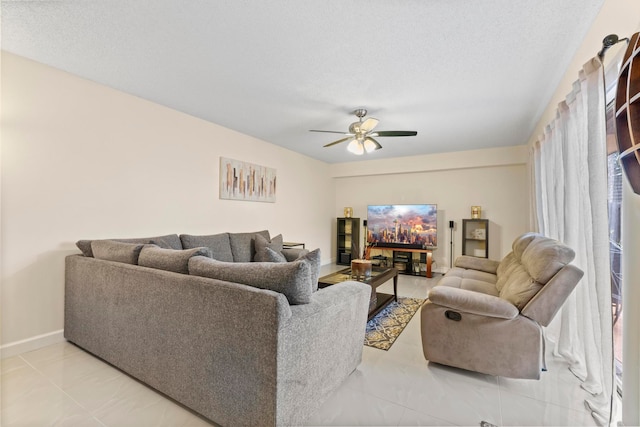 living room featuring a textured ceiling and ceiling fan