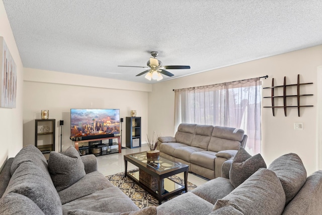 living room featuring a textured ceiling and ceiling fan