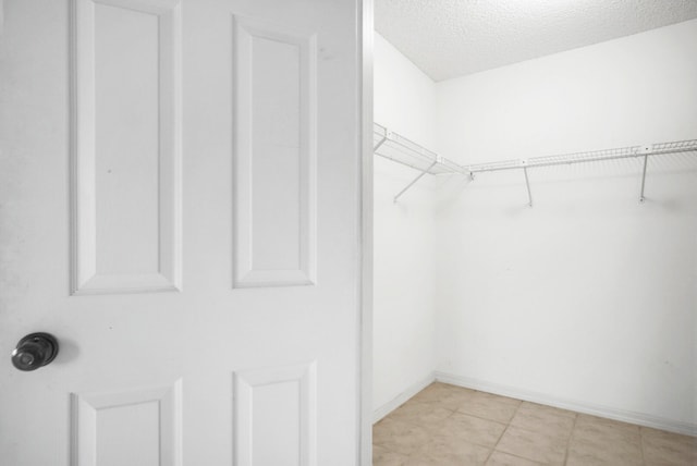 spacious closet with light tile patterned flooring