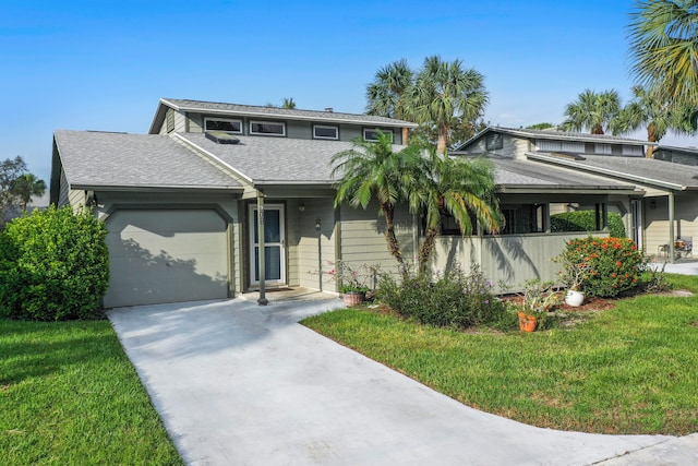 view of front of home featuring a front yard and a garage