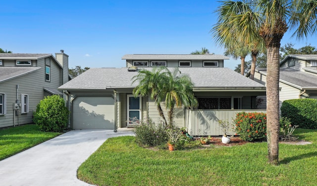 view of front of house with a front yard and a garage