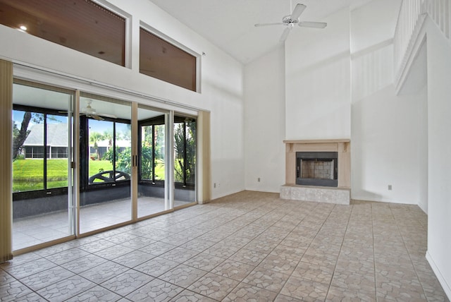 unfurnished living room with ceiling fan, high vaulted ceiling, and a wealth of natural light