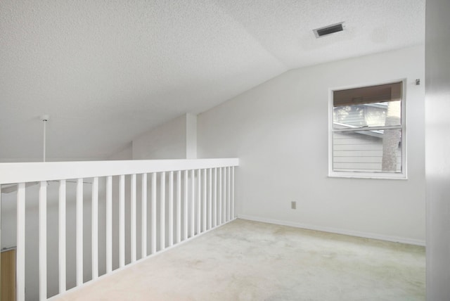 bonus room featuring light carpet, a textured ceiling, and vaulted ceiling