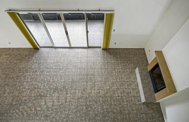 empty room featuring a glass covered fireplace