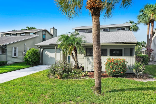 view of front facade featuring a front yard and a garage