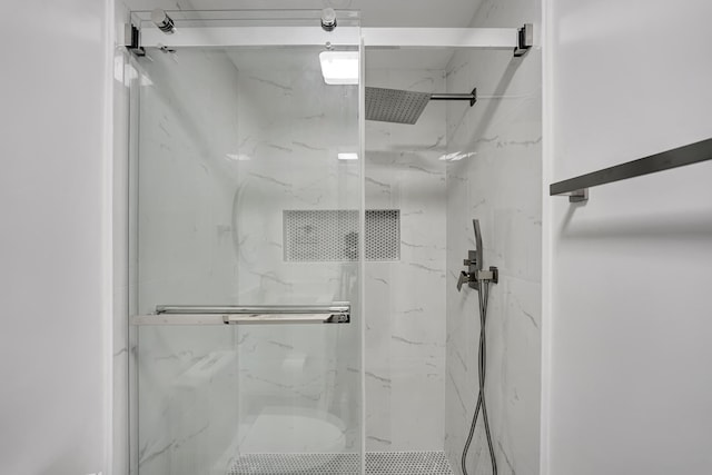 bathroom with a shower with shower door