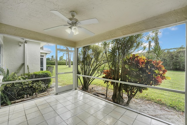 unfurnished sunroom featuring ceiling fan