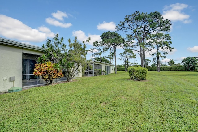 view of yard featuring a sunroom