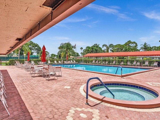 view of swimming pool with a patio and a community hot tub