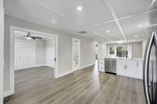 kitchen with wood ceiling, appliances with stainless steel finishes, white cabinetry, light hardwood / wood-style flooring, and sink