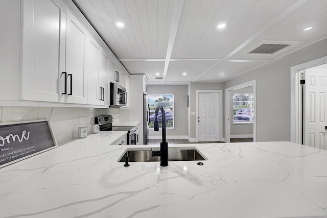 kitchen with white cabinets, light stone counters, wooden ceiling, sink, and stainless steel appliances