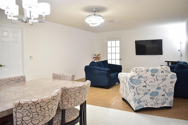 dining area with light hardwood / wood-style flooring and a notable chandelier