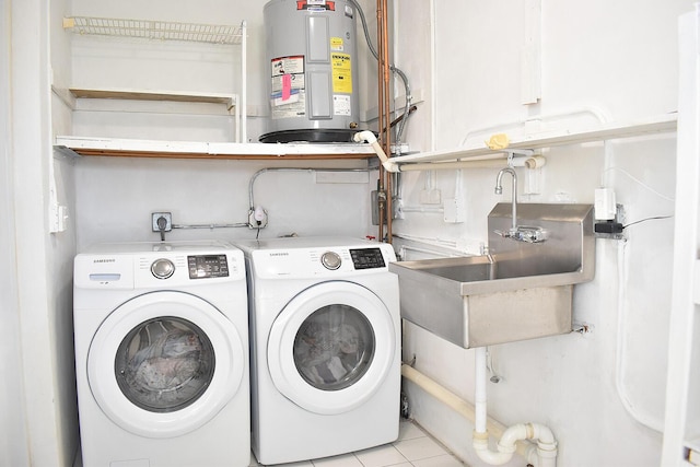 washroom featuring light tile patterned flooring, electric water heater, sink, and independent washer and dryer