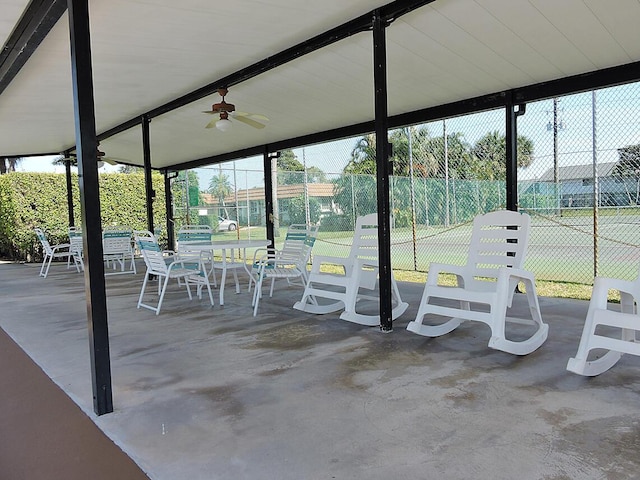 view of patio with tennis court and ceiling fan