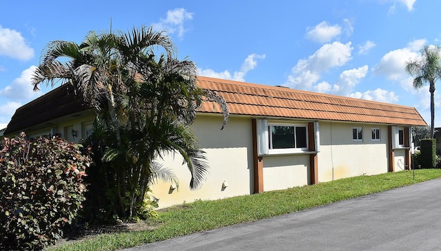 view of property exterior with a yard