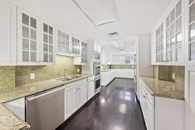 425 Worth Ave Unit 2F, Palm Beach, FL 33480 - kitchen featuring stainless steel appliances, a sink, white cabinets, and light stone counters