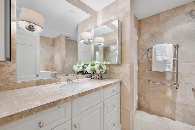 bathroom featuring vanity, tile walls, and backsplash