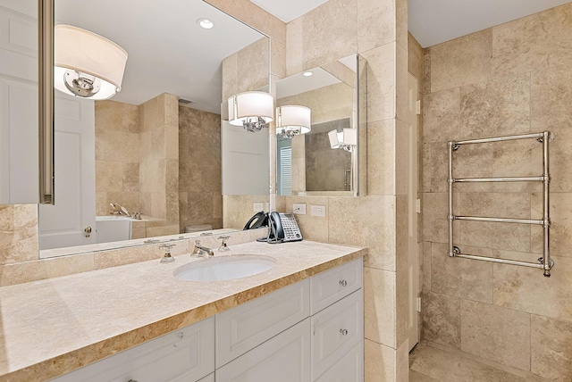 425 Worth Ave Unit 2F, Palm Beach, FL 33480 - full bathroom featuring tile walls, vanity, tiled shower, and a chandelier