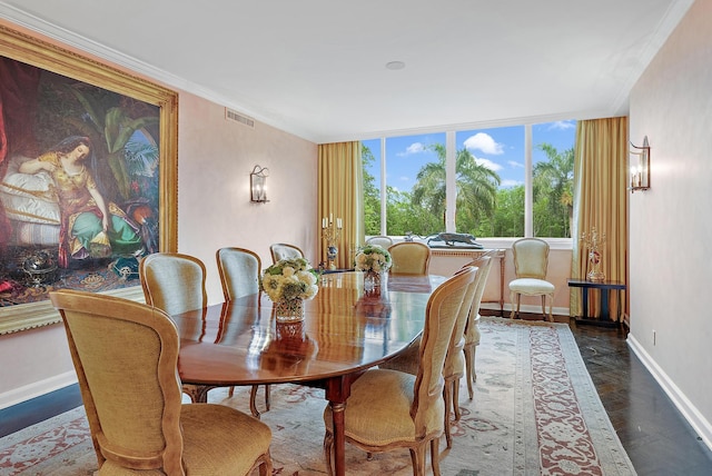 dining room with a wall of windows and crown molding