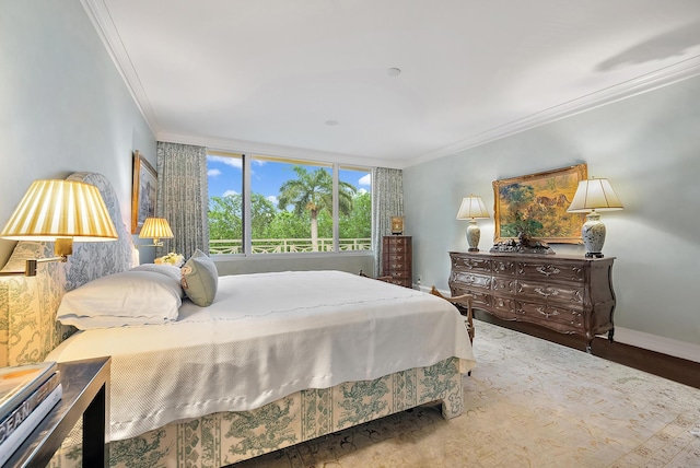 bedroom with hardwood / wood-style floors and crown molding