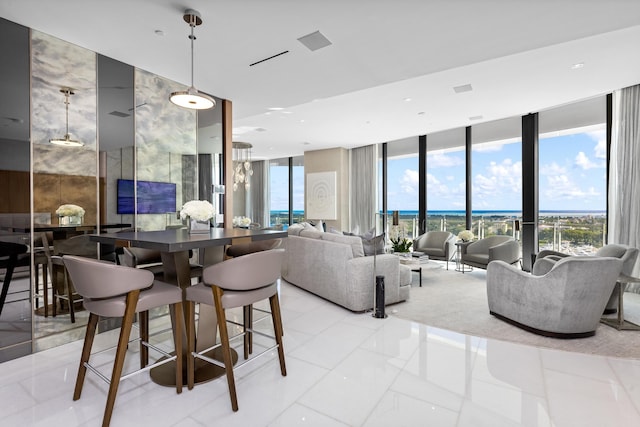 dining space featuring a wall of windows and a healthy amount of sunlight