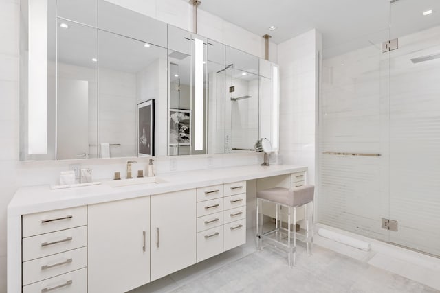 bathroom with vanity and a shower with shower door