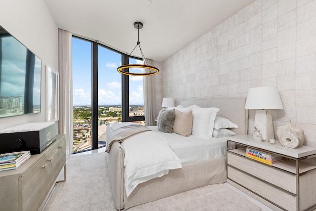 carpeted bedroom with tile walls and expansive windows