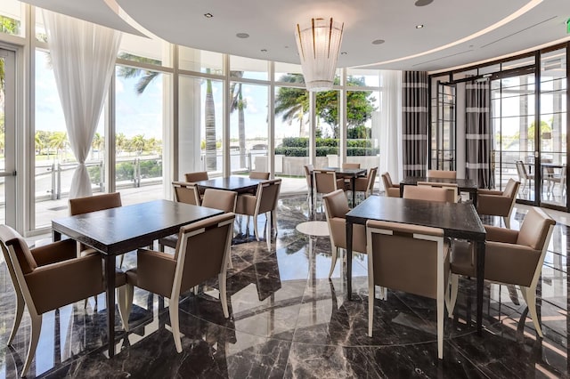 sunroom / solarium featuring an inviting chandelier