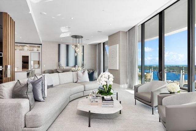 living room featuring floor to ceiling windows and a water view