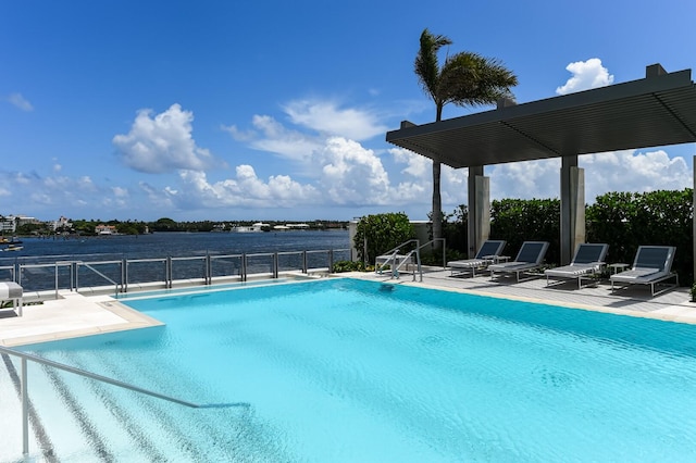 view of swimming pool with a water view and a patio