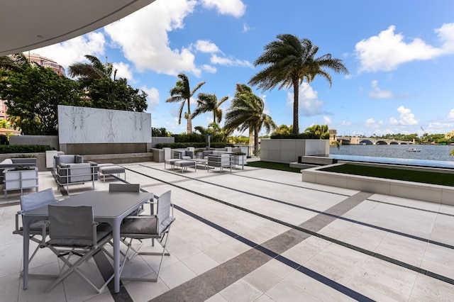 view of patio / terrace with an outdoor living space and a water view