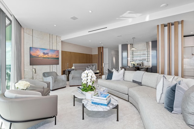 carpeted living room featuring a wall of windows