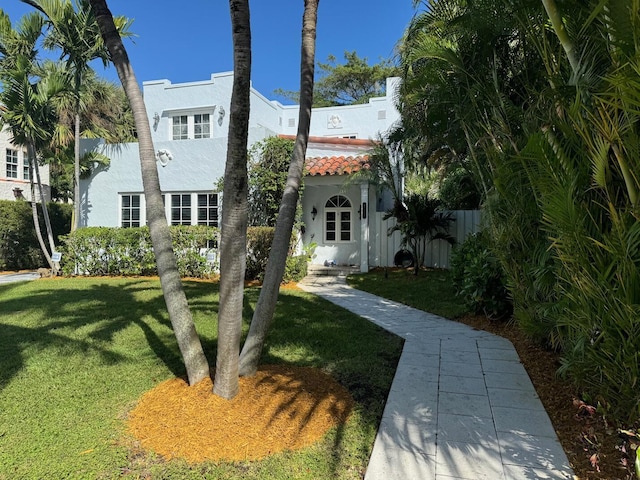 mediterranean / spanish house featuring a front yard