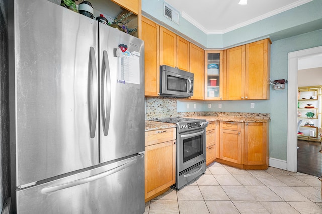 323 Dyer Rd, West Palm Beach, FL 33405 - kitchen featuring appliances with stainless steel finishes, ornamental molding, light stone counters, glass insert cabinets, and light tile patterned floors