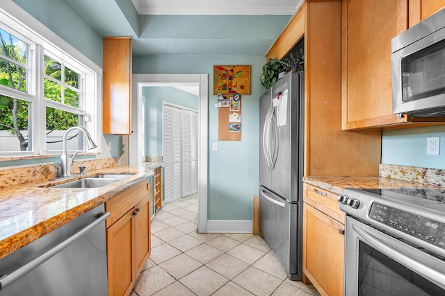 323 Dyer Rd, West Palm Beach, FL 33405 - kitchen featuring appliances with stainless steel finishes, a sink, light tile patterned floors, baseboards, and light stone countertops