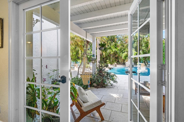 sunroom with french doors and beamed ceiling