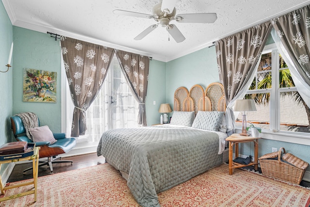 bedroom featuring ceiling fan, ornamental molding, and hardwood / wood-style flooring