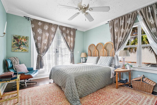 323 Dyer Rd, West Palm Beach, FL 33405 - bedroom with crown molding, wood finished floors, a textured ceiling, and ceiling fan