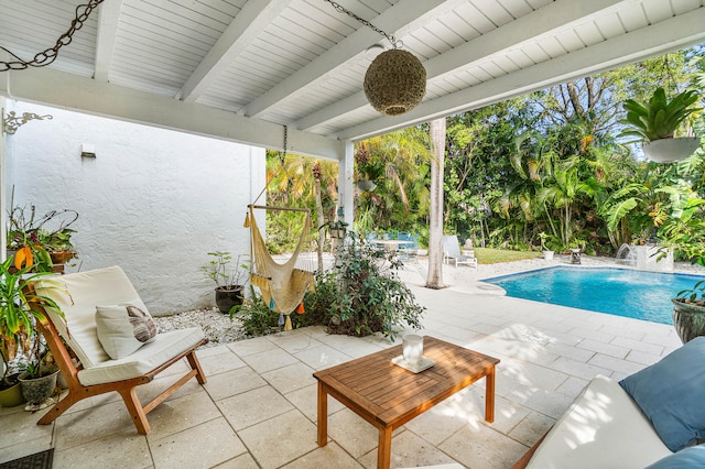 view of pool featuring pool water feature and a patio area