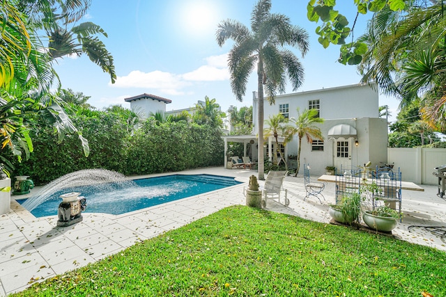 view of swimming pool with a patio area and a yard