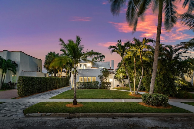 323 Dyer Rd, West Palm Beach, FL 33405 - view of front of property with curved driveway, a lawn, and stucco siding