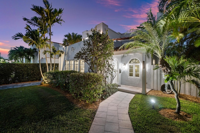 323 Dyer Rd, West Palm Beach, FL 33405 - view of front of home with stucco siding and a lawn