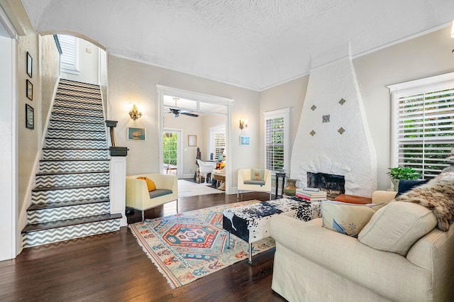 323 Dyer Rd, West Palm Beach, FL 33405 - living room with wood-type flooring, stairway, crown molding, a ceiling fan, and a fireplace