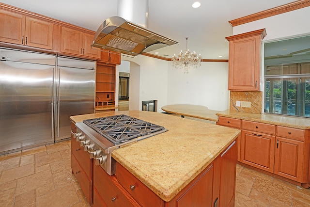 kitchen featuring island range hood, decorative backsplash, stainless steel appliances, crown molding, and a center island