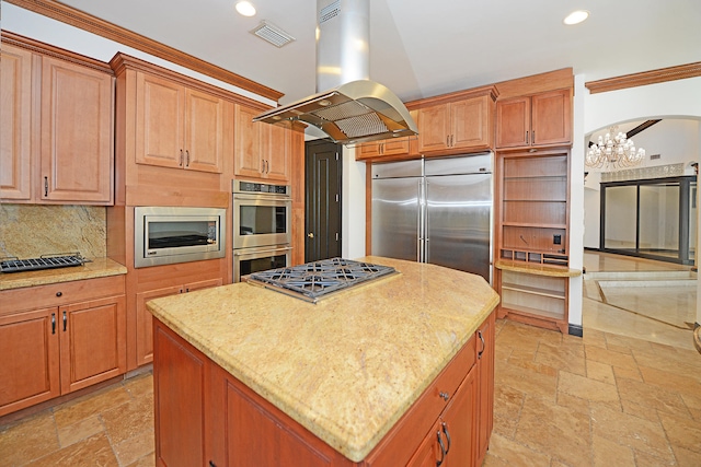 kitchen featuring island exhaust hood, decorative backsplash, a kitchen island, built in appliances, and ornamental molding