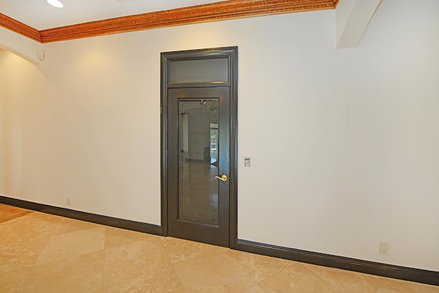 unfurnished room featuring tile patterned floors and ornamental molding