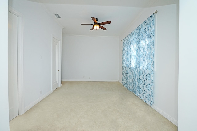 carpeted spare room featuring ornamental molding and ceiling fan