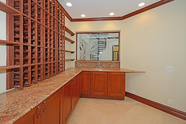 wine room with ornamental molding and sink