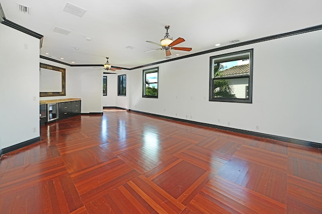 unfurnished living room with wine cooler, crown molding, dark parquet floors, and ceiling fan